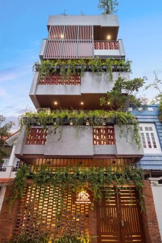 a building with a balcony with plants on it at An Hiên Home in Danang