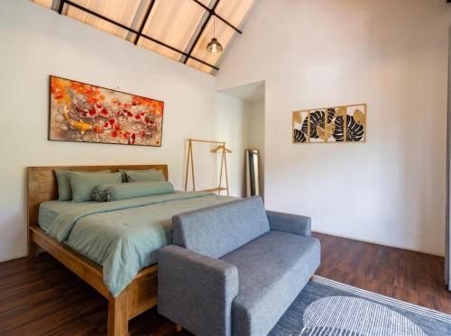 a bedroom with a bed and a chair at Private Cabin in Bandung