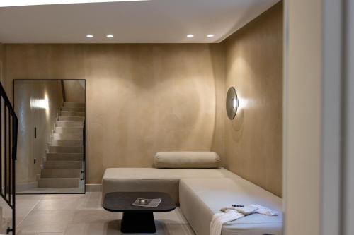 a room with a bed and a table and stairs at Melidron Hotel Suites Villas in Agios Prokopios