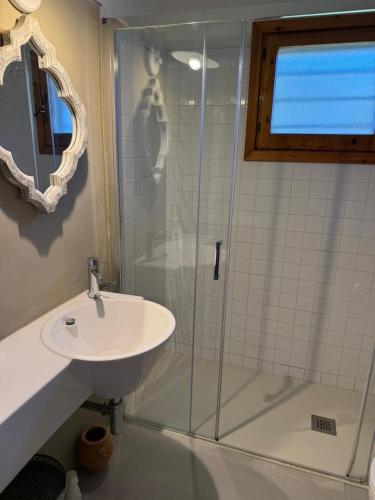 a bathroom with a sink and a glass shower at Villa Ira Gongilo R9048 in Porto Rotondo