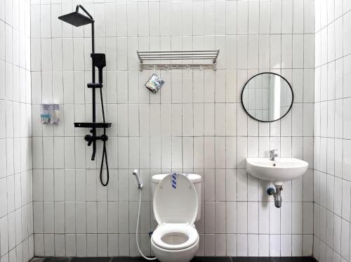 a bathroom with a toilet and a sink at Heavenly 2 - Private Triangle in Bandung