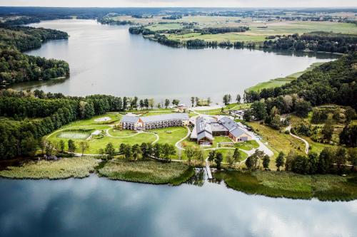 an aerial view of a house on an island in a lake at Hotel Marina Club in Olsztyn