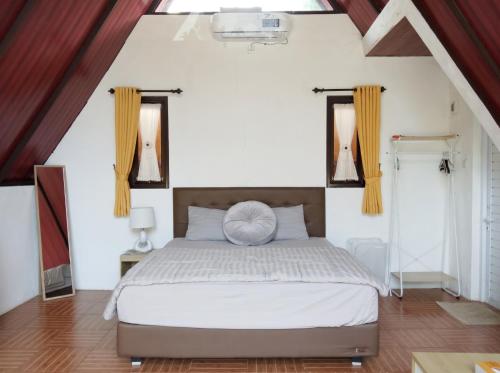 a bedroom with a bed and two windows at Heavenly 1 - Private Triangle in Bandung