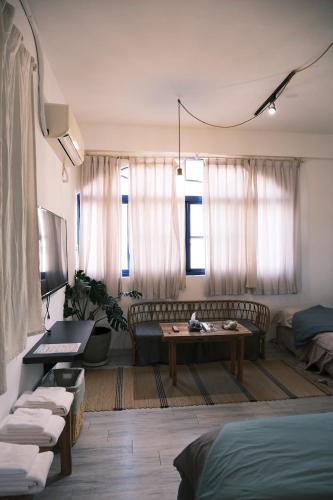 a living room with a couch and a table at Island River in Green Island