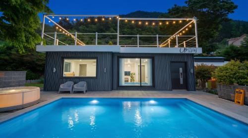 a house with a swimming pool in the backyard at Namhae U9Stay in Namhae
