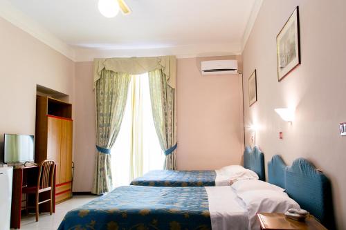 a hotel room with a bed and a window at Hotel Altavilla 9 in Rome
