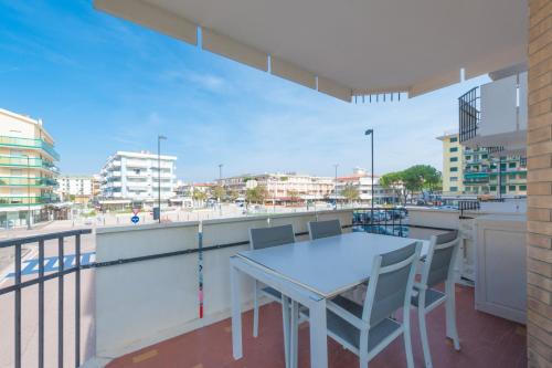a table and chairs on a balcony with a view of the beach at Residence Playa Grande Immobiliare Pacella in Lido di Jesolo