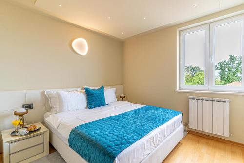 a bedroom with a large bed and a window at Sunny Day self check in in Rijeka