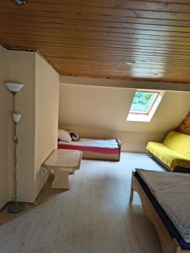 a room with two bunk beds and a window at Osada leśna in Sztabin
