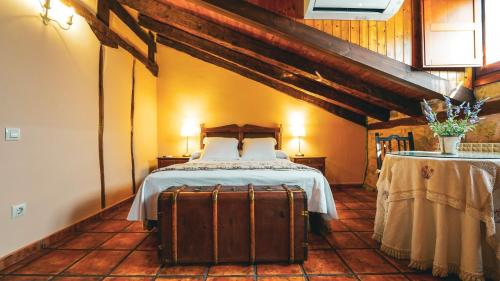 a bedroom with a bed and a suitcase at La Casona de Lucía in Sigüenza