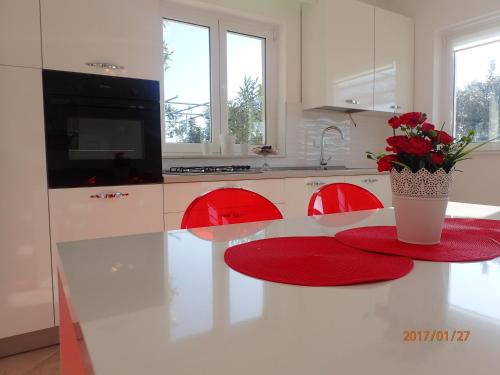 eine Küche mit einem Tisch und einer Blumenvase darauf in der Unterkunft Apartment Villa Bonadea in Slano