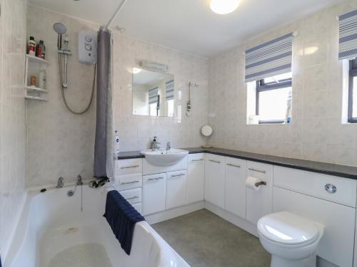 a bathroom with a tub and a toilet and a sink at 38 St Margarets in Dover
