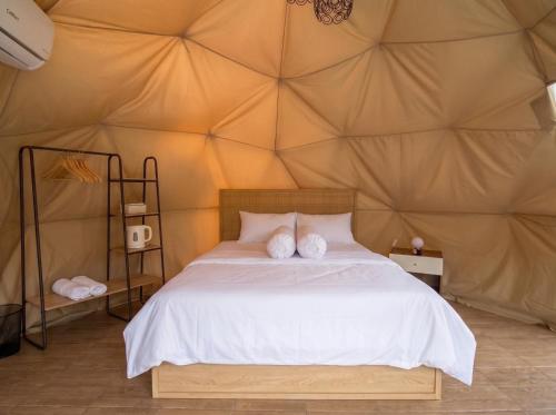 a bedroom with a bed in a tent at Hanara Private Glamping in Panjadakan