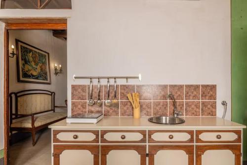 a kitchen with a sink and a counter top at Due Borghi Guest House in Pisa
