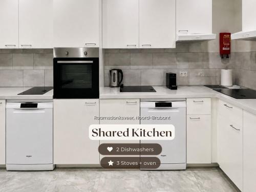 a kitchen with white cabinets and a sign that reads shared kitchen at Vibrant Raamsdonksveer, near Efteling & Biesbosch in Raamsdonksveer
