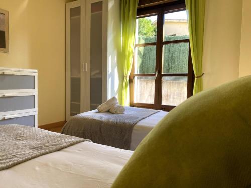 a bedroom with two beds and a window at R2R - El Rincón de Luiña - 310A in Soto de Luiña