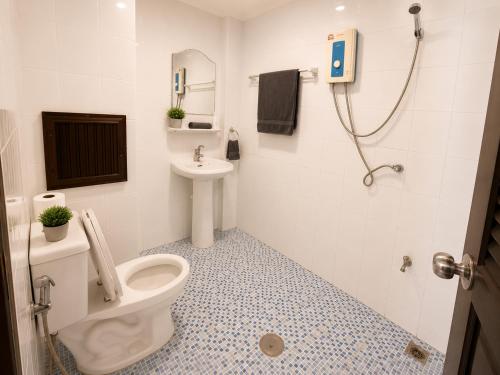 a bathroom with a toilet and a sink and a shower at Hill Side Patong in Patong Beach