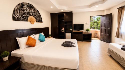 a bedroom with a large bed and a living room at Hill Side Patong in Patong Beach