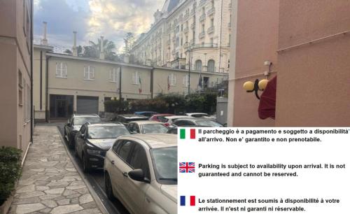 a row of parked cars on a street with buildings at Hotel Principe in Sanremo
