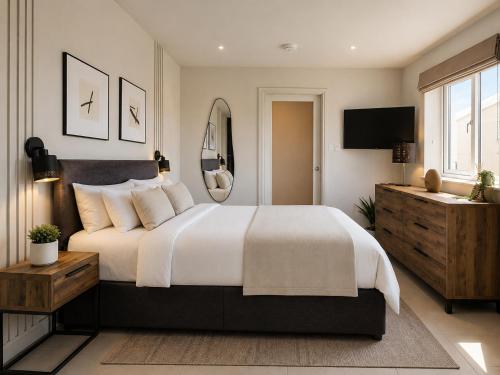a bedroom with a large bed and a television at Crossways in Wells