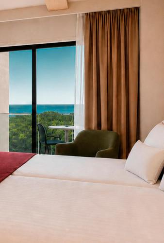 a hotel room with a bed and a large window at Aura by Aubamar in Playa de Palma