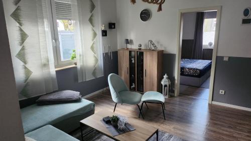 a living room with a couch and a chair at Ferien-, Monteurswohnung in Bottrop in Bottrop