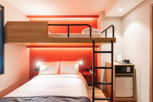 a bedroom with a bunk bed with an orange headboard at Best Western Insadong Hotel in Seoul