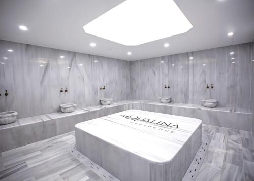 a bathroom with four sinks and a large white table at Aqualina D5-1 by HolidayKeys in Kyrenia