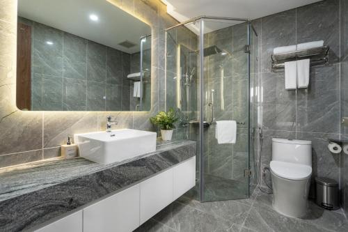 a bathroom with a sink and a toilet and a shower at Caballos Apartment Capital Elite in Hanoi