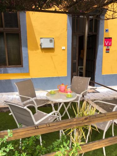 two chairs and a table in front of a house at Charming house in Teror with garden in Teror