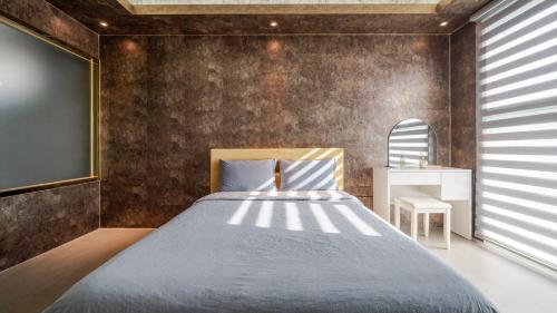 a bedroom with a large bed and a chalkboard at Chuncheon Poolhouse Epop in Chuncheon