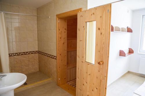 a bathroom with a shower with a toilet and a sink at Hotel Auto Jas in Nitra