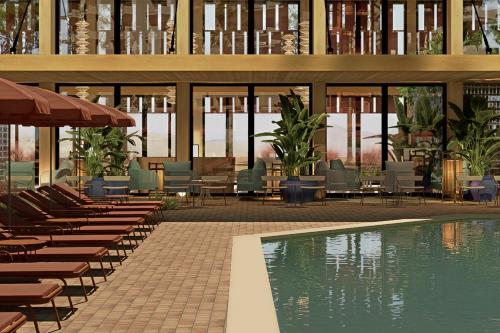 a resort with a pool and chairs and a building at Aura by Aubamar in Playa de Palma