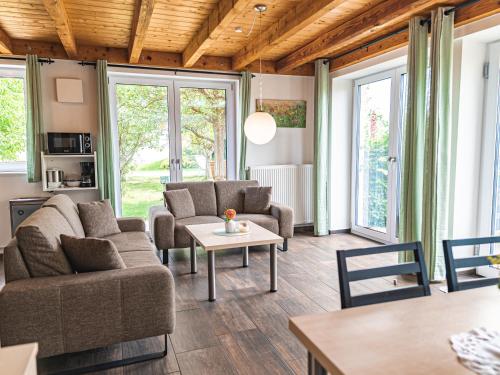 a living room with two couches and a table at Ferienhof Häckler in Ochsenhausen