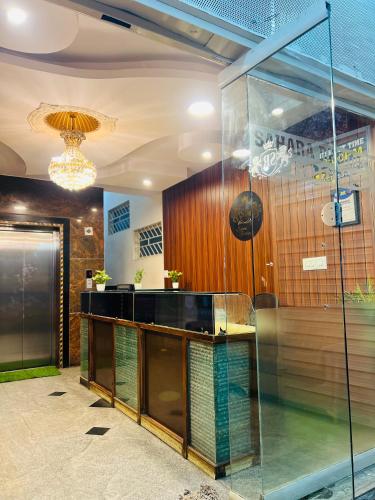 a lobby with a glass counter in a building at Sahara Residency Mysore in Mysore