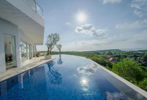 a swimming pool in a house with a view at Villa Aventus Uluwatu in Uluwatu