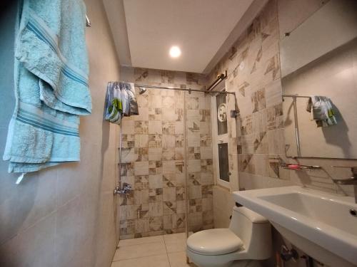 a bathroom with a toilet and a sink at Luxe Villa in Murree
