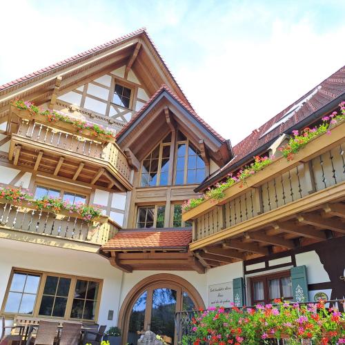 a house with wooden balconies and flowers on it at Bäuerlehof in Seebach