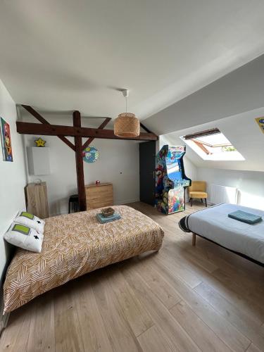 a bedroom with two beds and a play room at Super Mario Studio ! in Jaunay-Clan