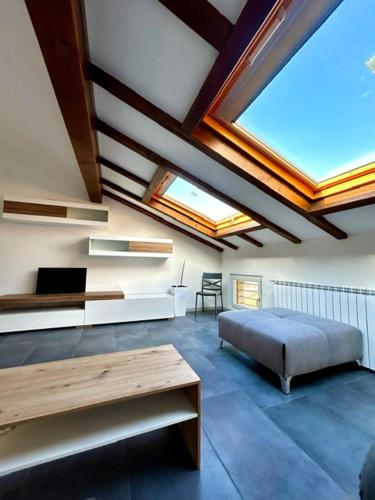a room with a bed and a table and windows at CARDAHAUSe Via DANTE 12 in Cogliate