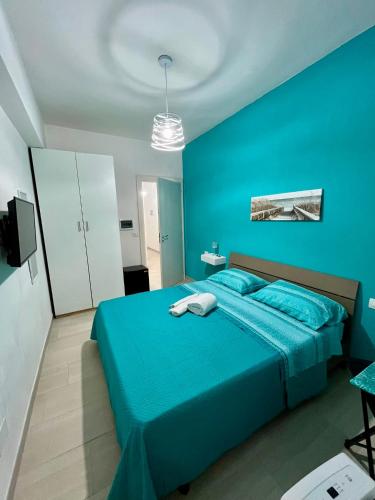 a blue bedroom with a bed and a blue wall at B&B Tribale in Ercolano