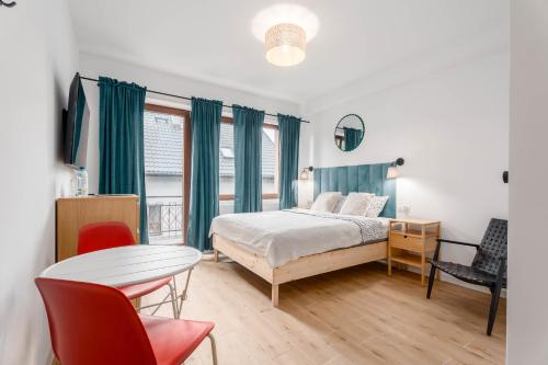 a bedroom with a bed and a table and chairs at Enjoy! Piaseczno in Piaseczno