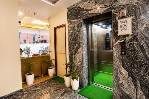 an entrance to a building with a green floor at Sunburry Hotel Tapovan Rishikesh in Narendranagar