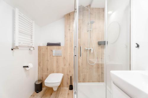 a bathroom with a shower and a toilet and a sink at Enjoy! Piaseczno in Piaseczno
