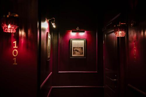 a dark room with red lights on the walls at Eurostars Josefine in Vienna