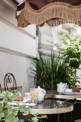 a table with a tea set on top at Eurostars Josefine in Vienna