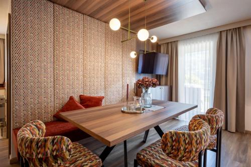 a dining room with a wooden table and chairs at Apart Denise in Fügen