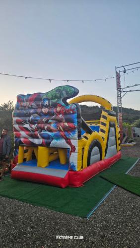 a colorful inflatable bounce house on a playground at extreme park in Deir Ḥannā