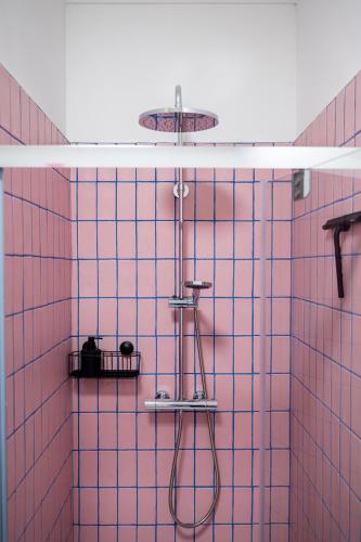 a pink tiled shower with a shower head at Cool Cool House in Liège