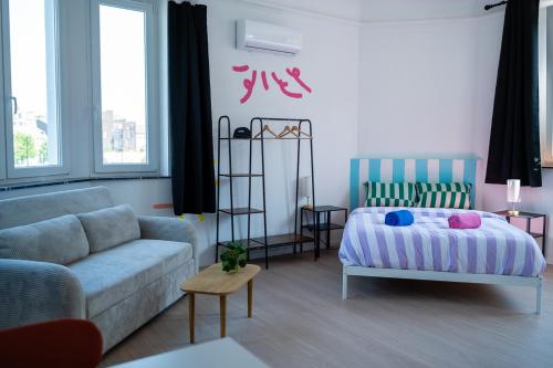 a living room with a couch and a bed at Cool Cool House in Liège